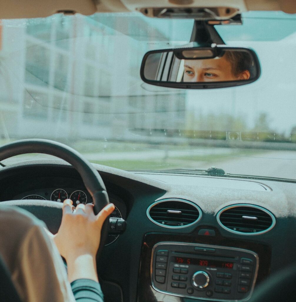 Ophthalmologist Stockerau 5 Woman driving car, eyes visible in rearview mirror